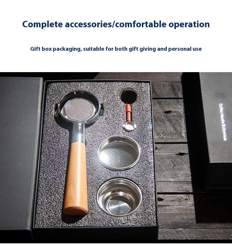 A coffee preparation accessory set displayed in an open black gift box on a dark wooden surface. The set includes a metal and wood-handled tool, a small metal container, a round metal cup, and a small orange-handled tool, with text above describing complete accessories and gift box packaging.
