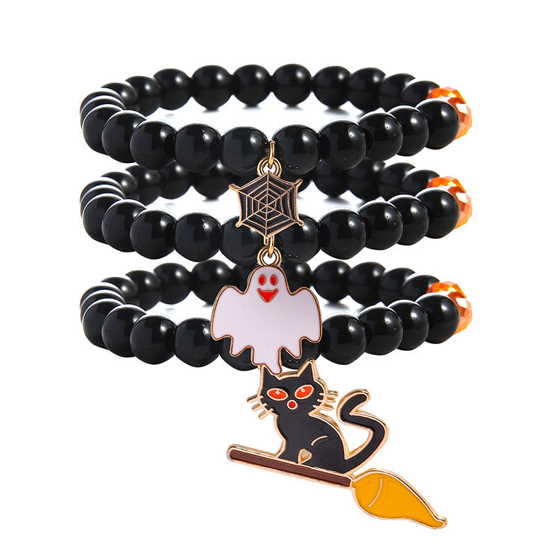 252678300-2 Three stacked black beaded Halloween bracelets with gold-tone-edged spiderweb, smiling white ghost and black cat charms.
