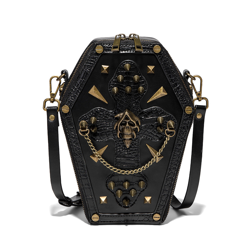 390374250-6 - Black coffin-shaped crossbody bag with a textured studded cross, hooded skull centerpiece and gold-tone chain.
