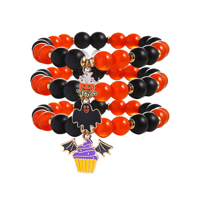 703722611-3 Three orange and black beaded Halloween bracelets with ghosts in a pumpkin, a black ghost and a purple bat-wing cupcake.
