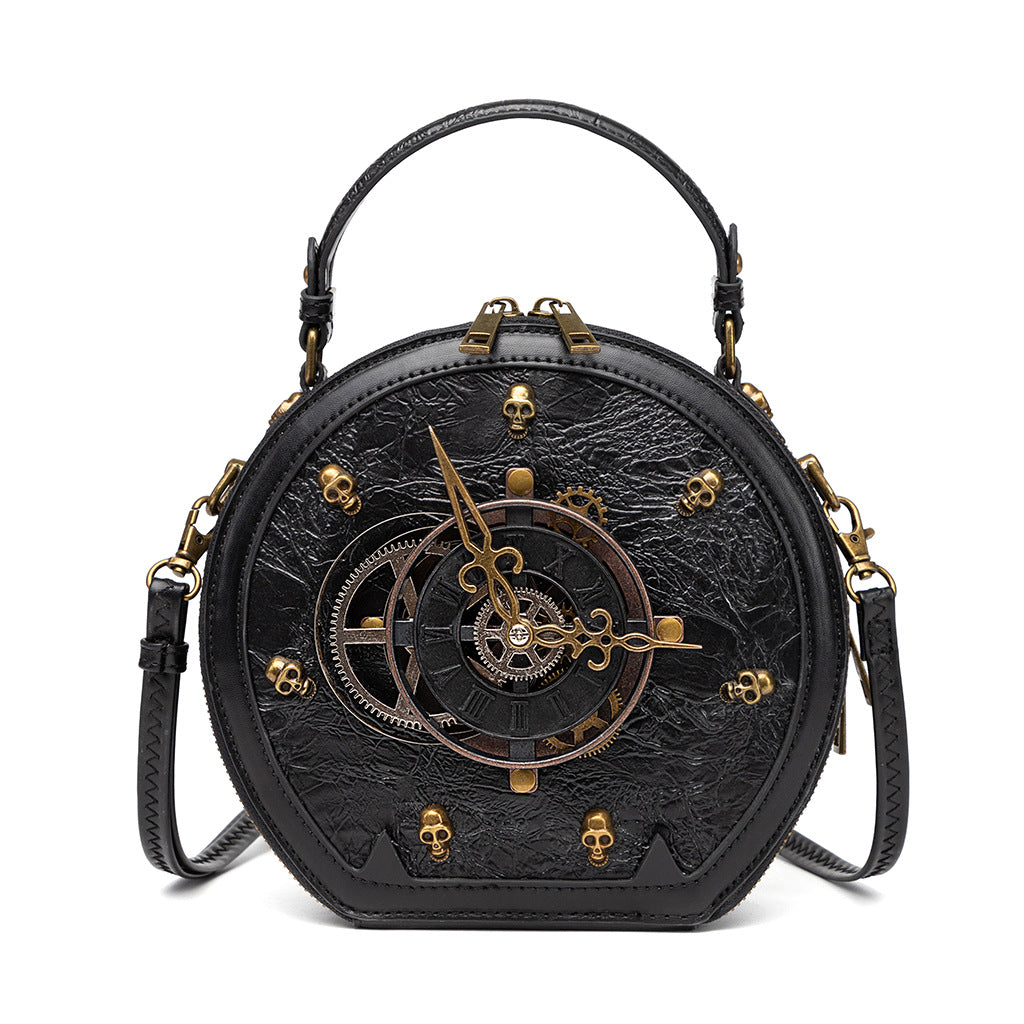 115882922-3 - Round black steampunk crossbody bag with decorative clock hands, gears, gold-tone skull accents and a top handle.
